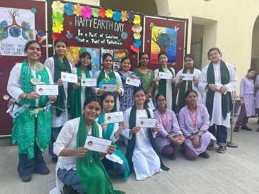 Students displaying Earth Day pledge cards at school